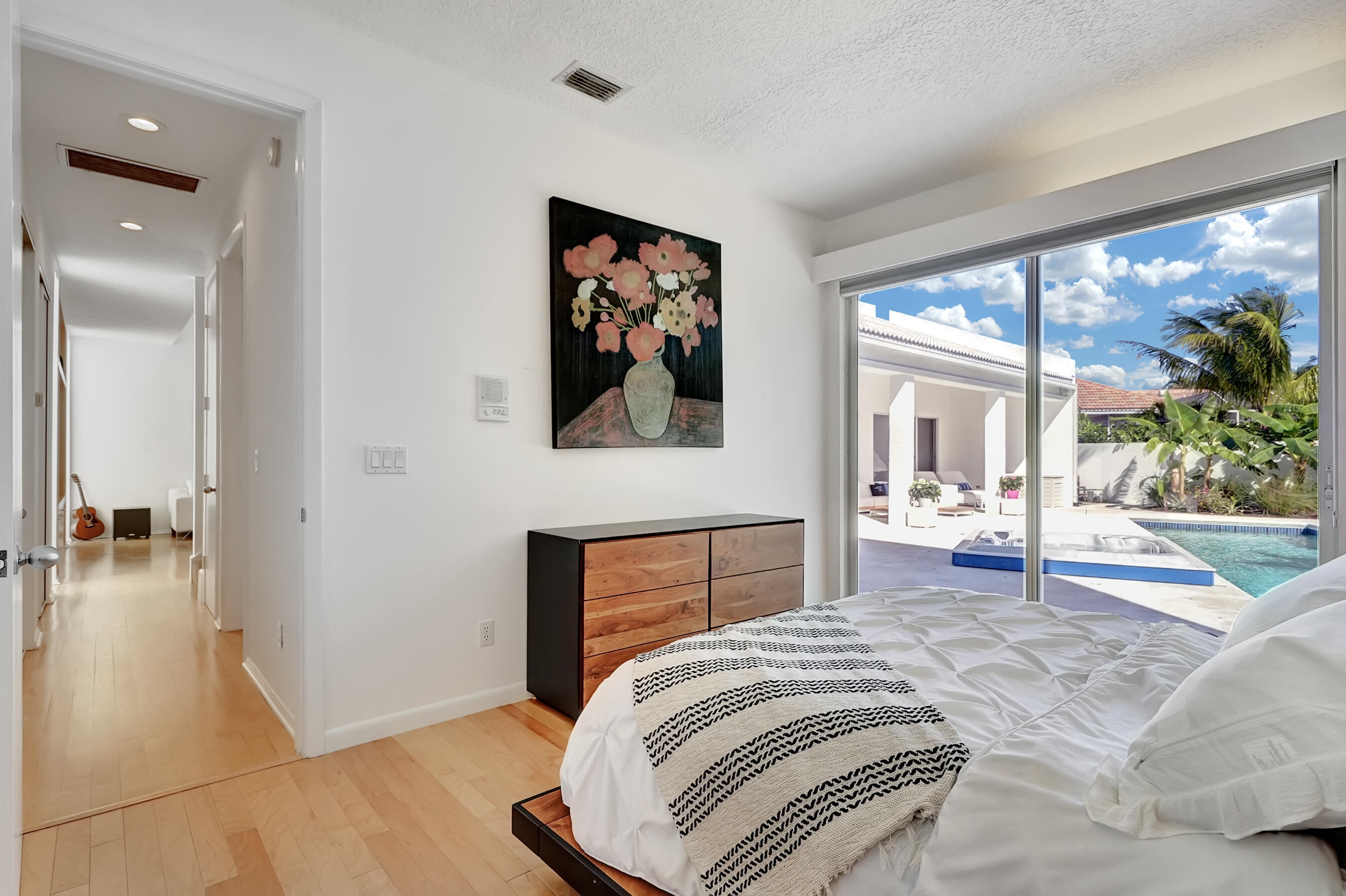 114 Olympus Circle Jupiter, FL 33477 - Photo 41 of 88 a bedroom with a bed and a large window