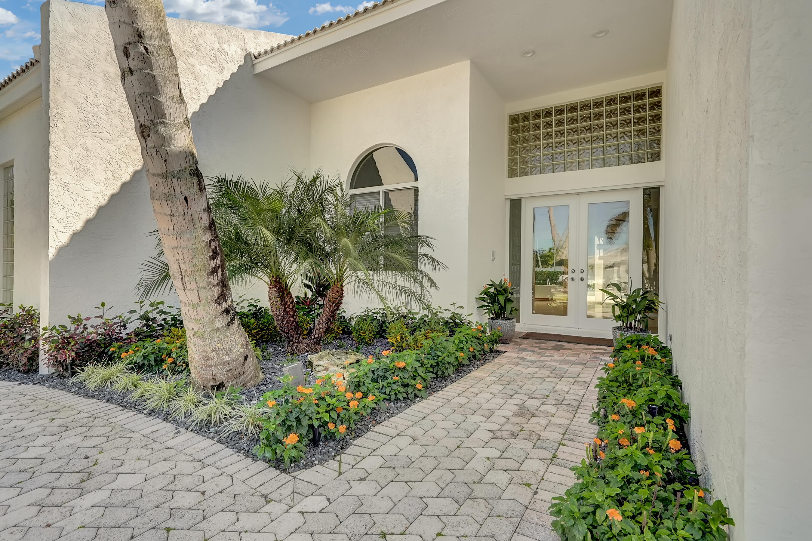 114 Olympus Circle Jupiter, FL 33477 - Photo 5 of 88 a front view of a house with a yard