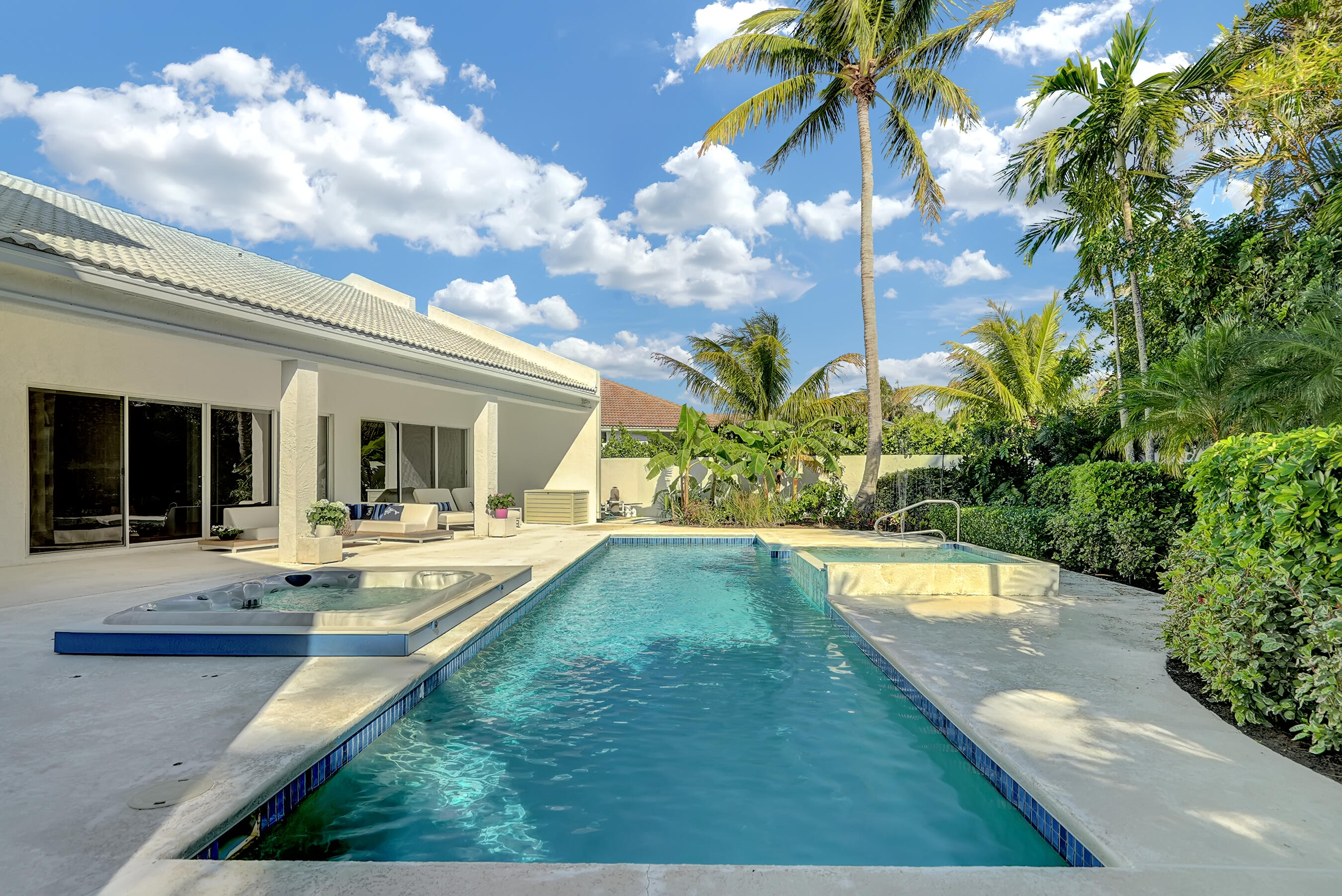114 Olympus Circle Jupiter, FL 33477 - Photo 60 of 88 a view of a house with swimming pool and sitting area
