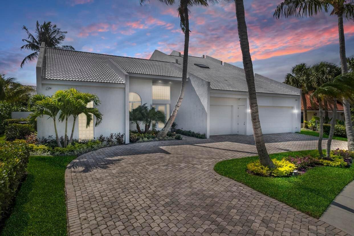 114 Olympus Circle Jupiter, FL 33477 - Photo 72 of 88 a front view of a house with garden