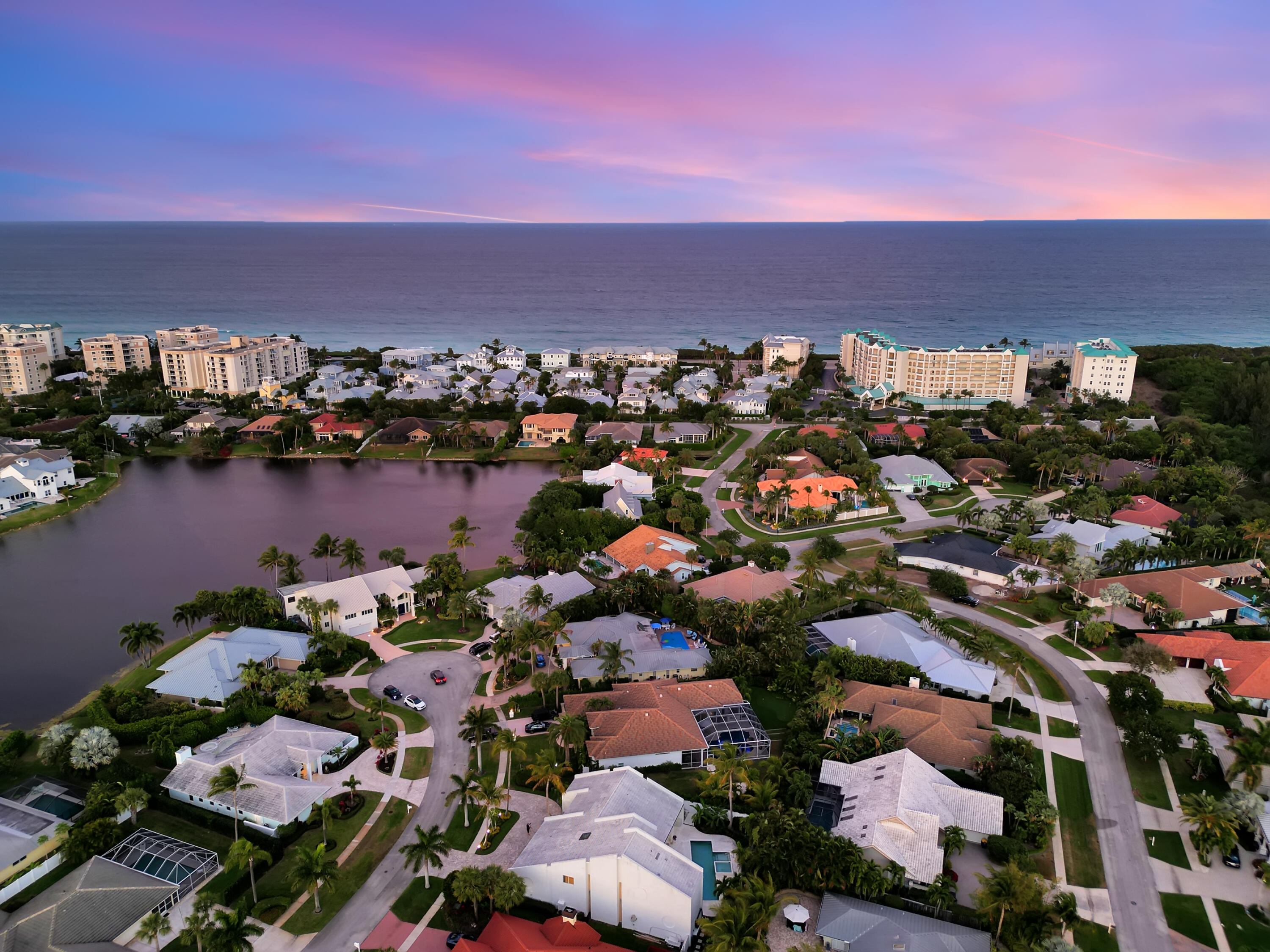 114 Olympus Circle Jupiter, FL 33477 - Photo 74 of 88 an aerial view of a city with lots of residential buildings and ocean view in back