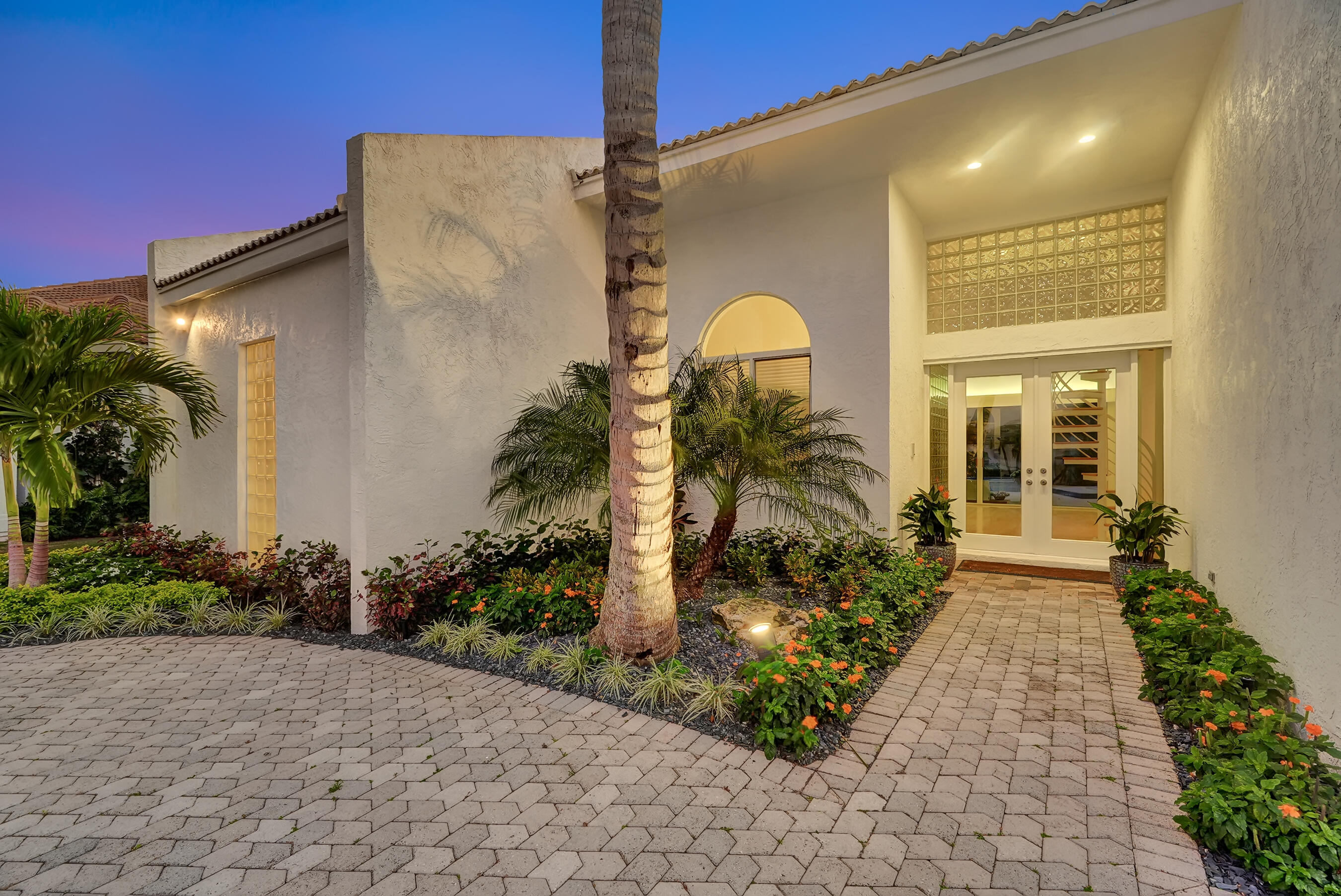 114 Olympus Circle Jupiter, FL 33477 - Photo 81 of 88 a front view of a house with garden