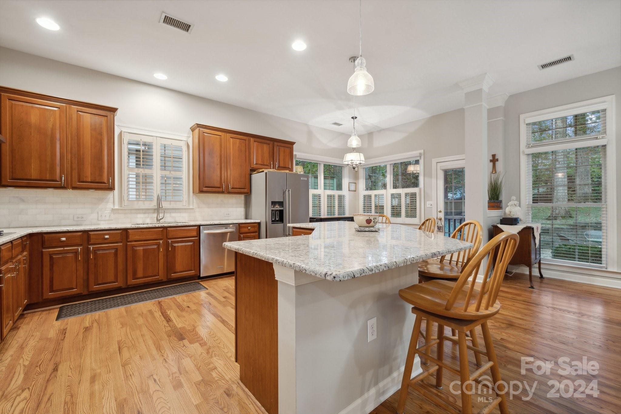 8610 Brentfield Road Huntersville, NC 28078 - Photo 11 of 48 a kitchen with stainless steel appliances granite countertop a sink and a wooden cabinets