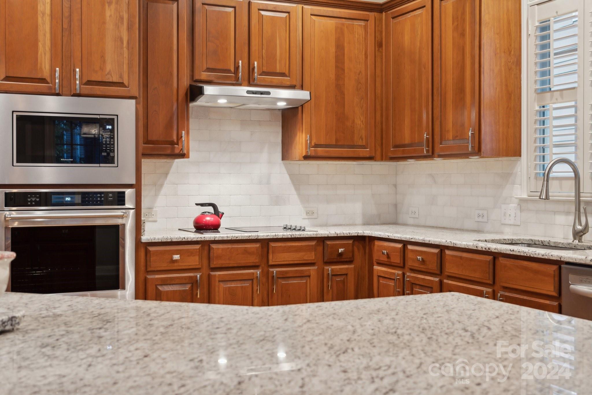 8610 Brentfield Road Huntersville, NC 28078 - Photo 12 of 48 a kitchen with granite countertop a stove sink and cabinets