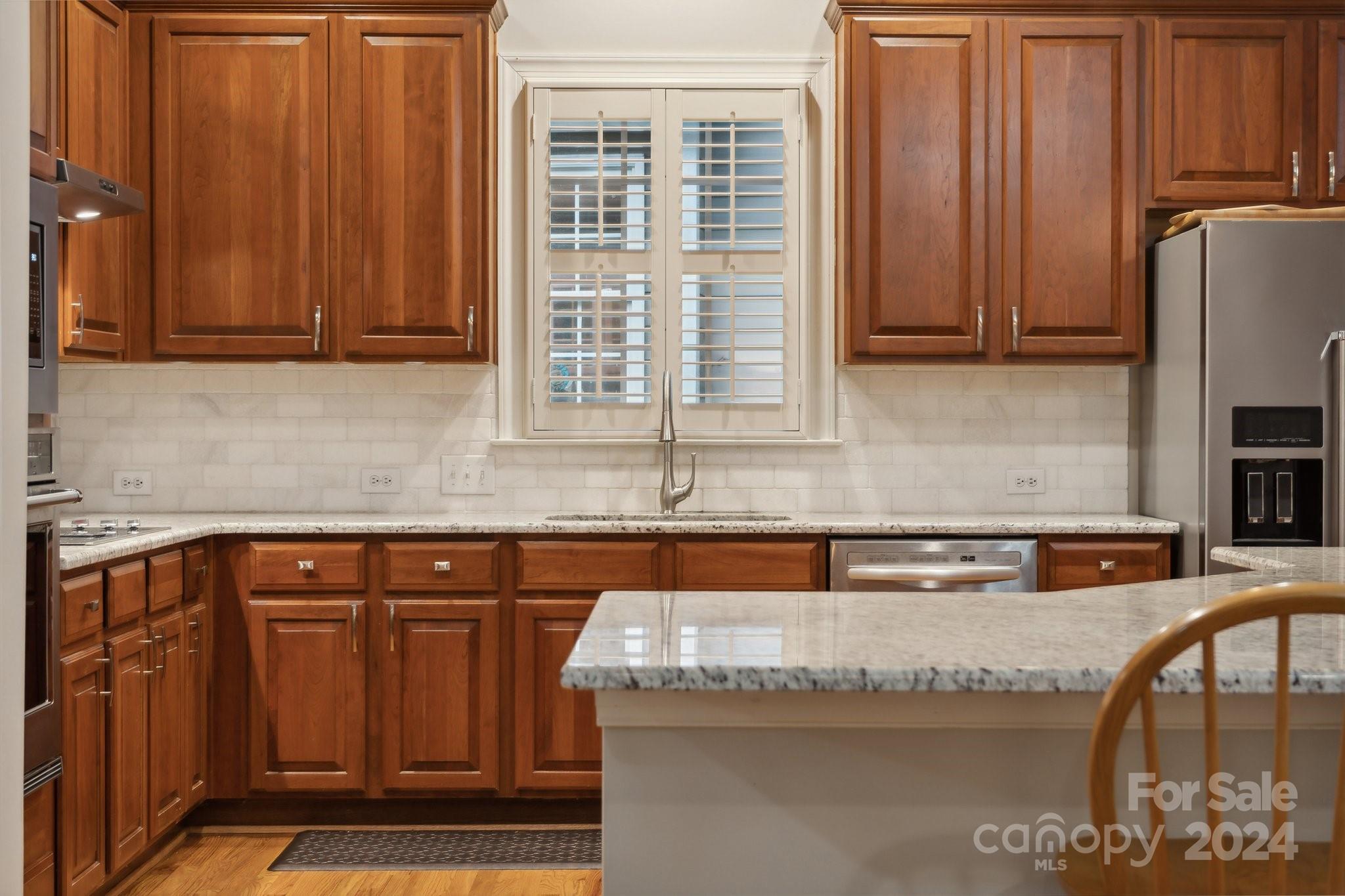 8610 Brentfield Road Huntersville, NC 28078 - Photo 13 of 48 a kitchen with granite countertop a sink a stove and cabinets