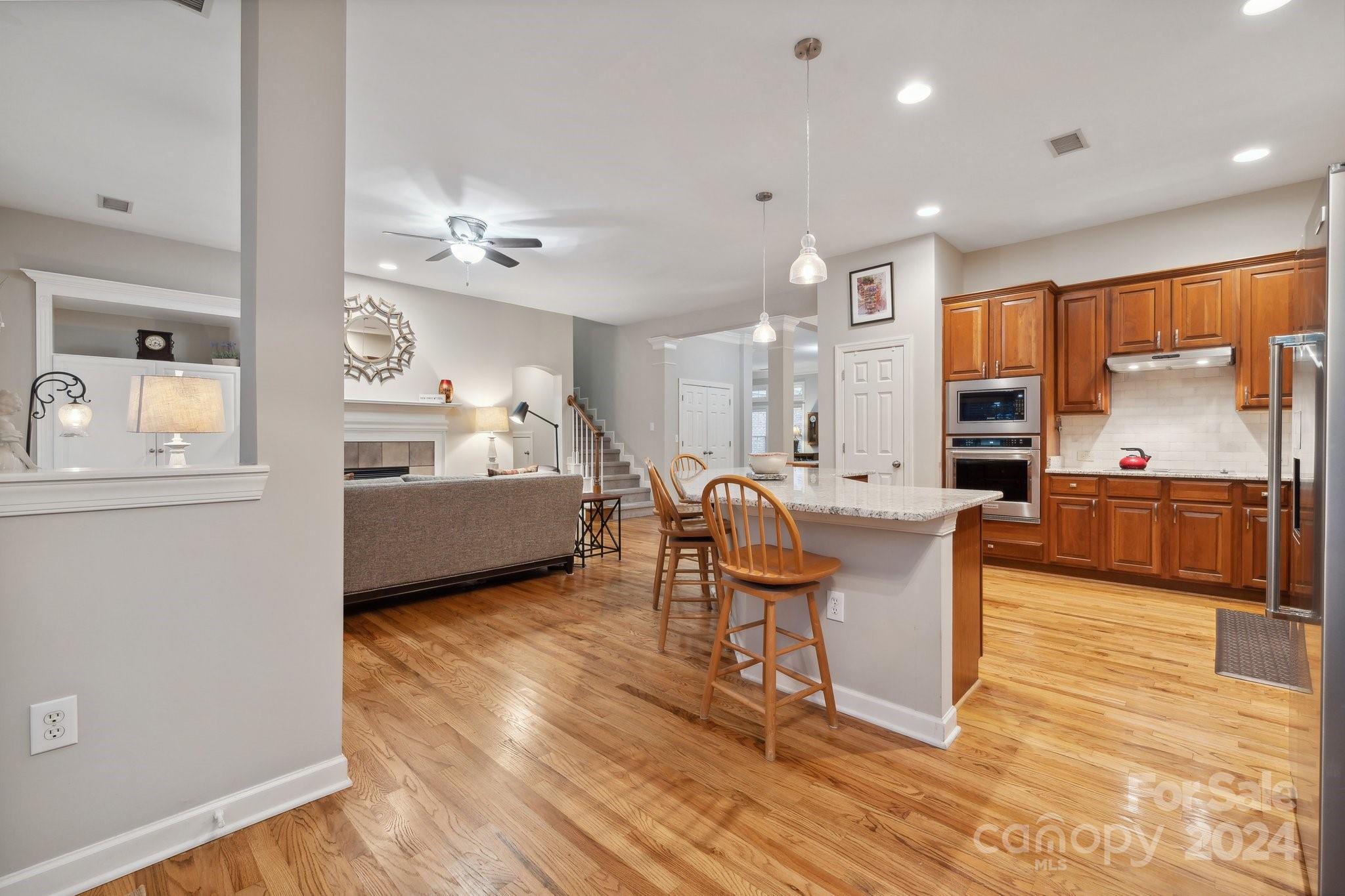 8610 Brentfield Road Huntersville, NC 28078 - Photo 14 of 48 a living room with couches kitchen view and a large window