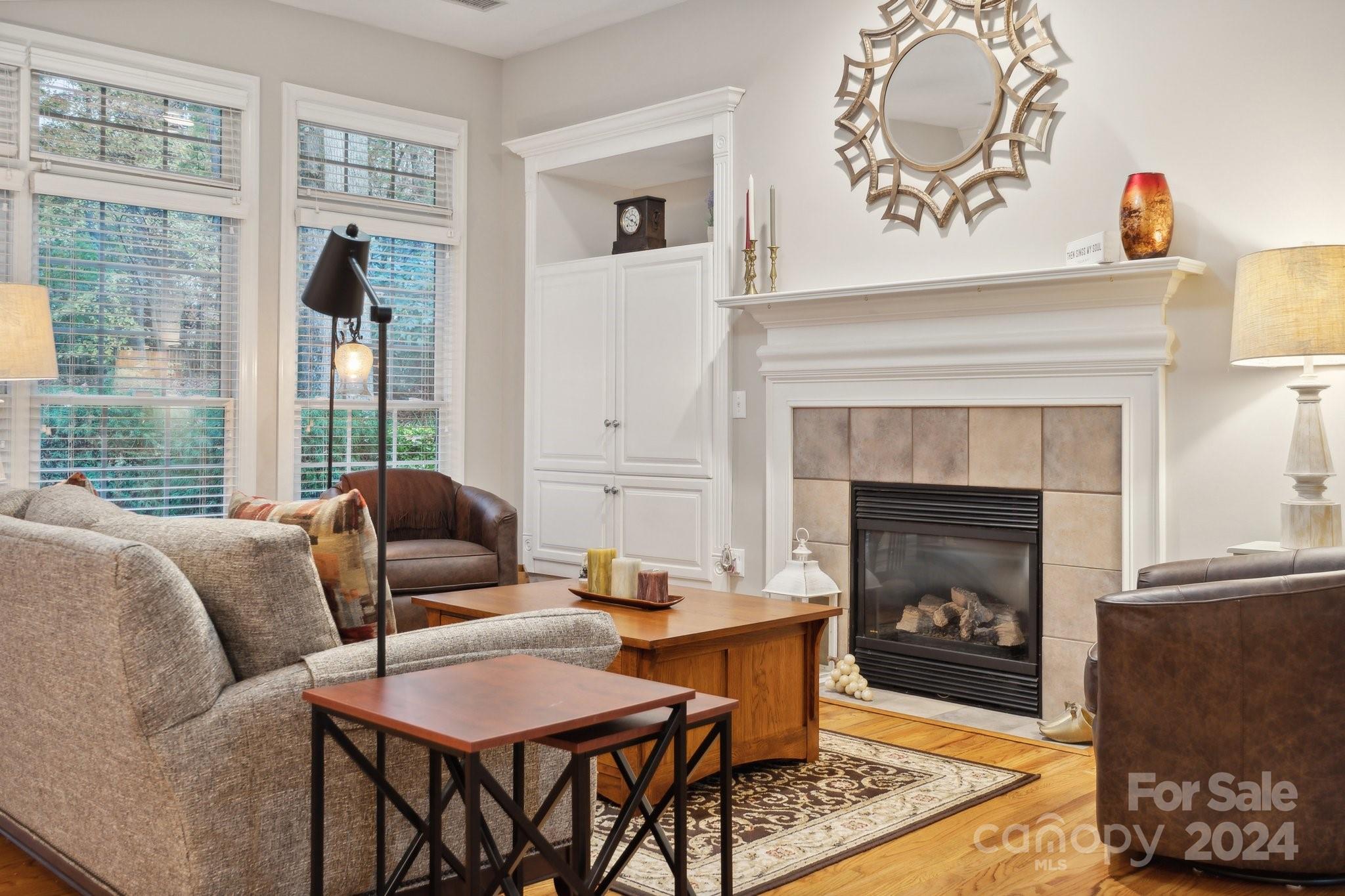 8610 Brentfield Road Huntersville, NC 28078 - Photo 19 of 48 a living room with furniture a flat screen tv and a fireplace