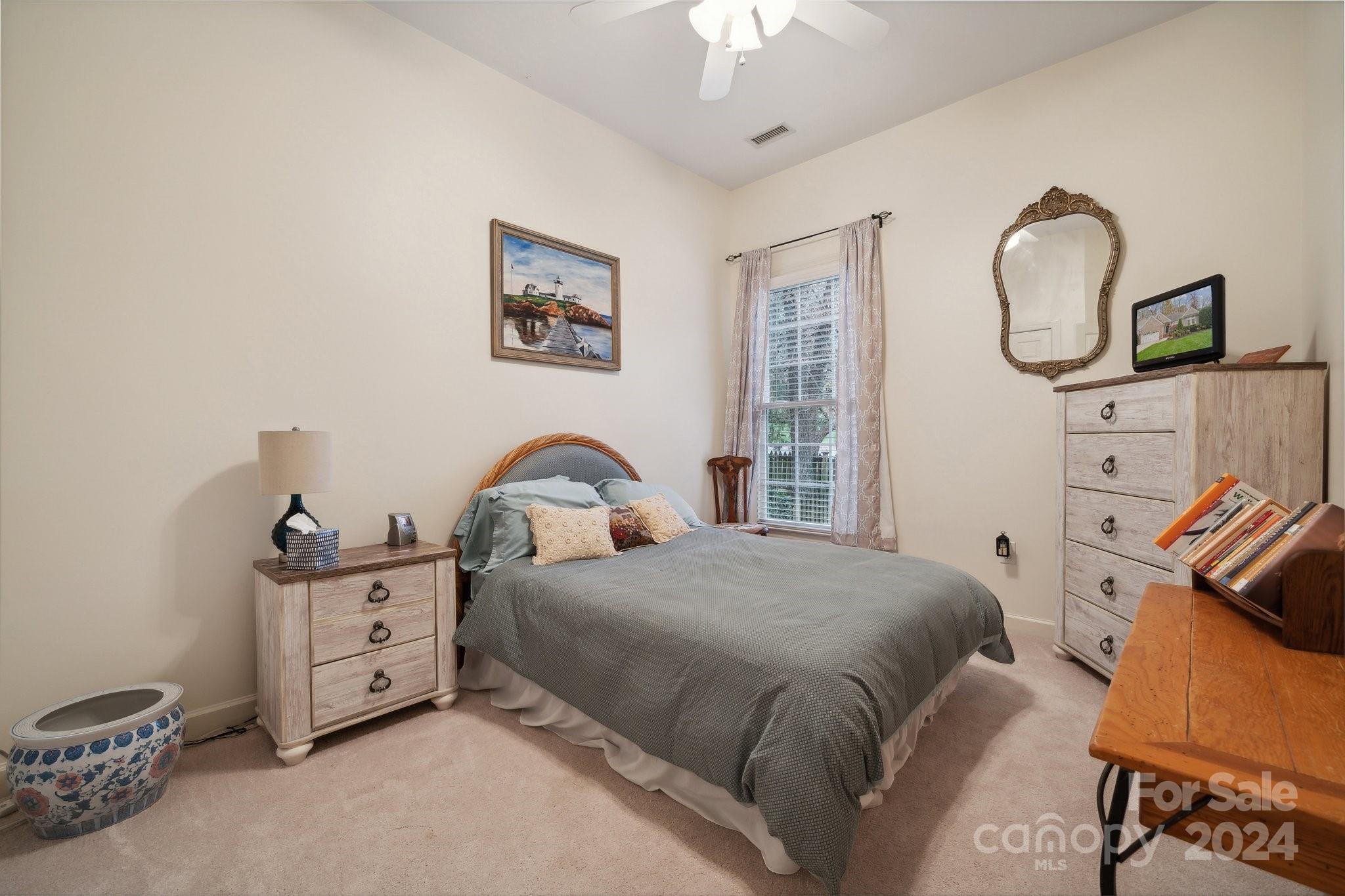 8610 Brentfield Road Huntersville, NC 28078 - Photo 27 of 48 a bedroom with a bed a chandelier and dresser