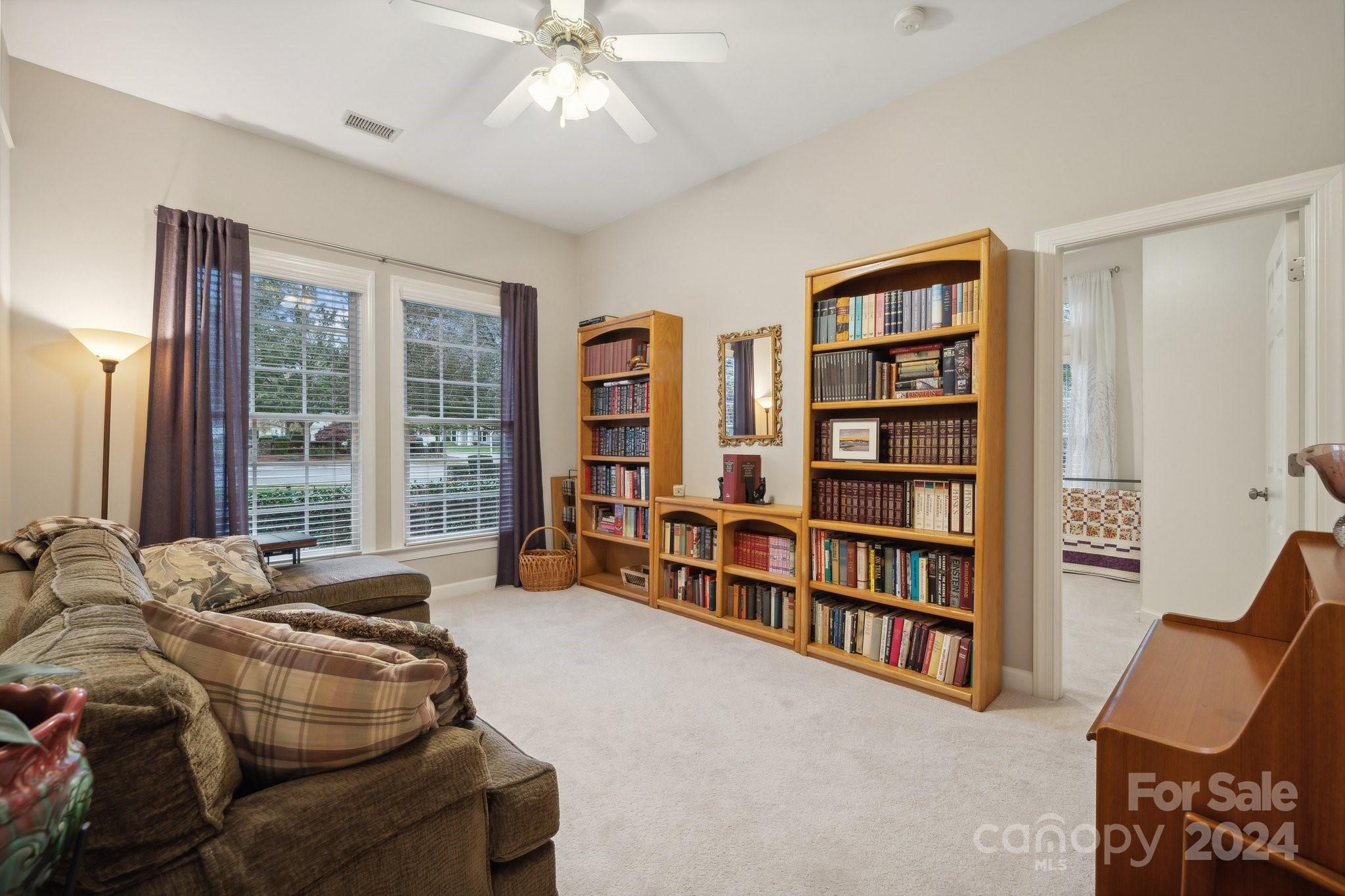 8610 Brentfield Road Huntersville, NC 28078 - Photo 30 of 48 a bedroom with furniture and a book shelf
