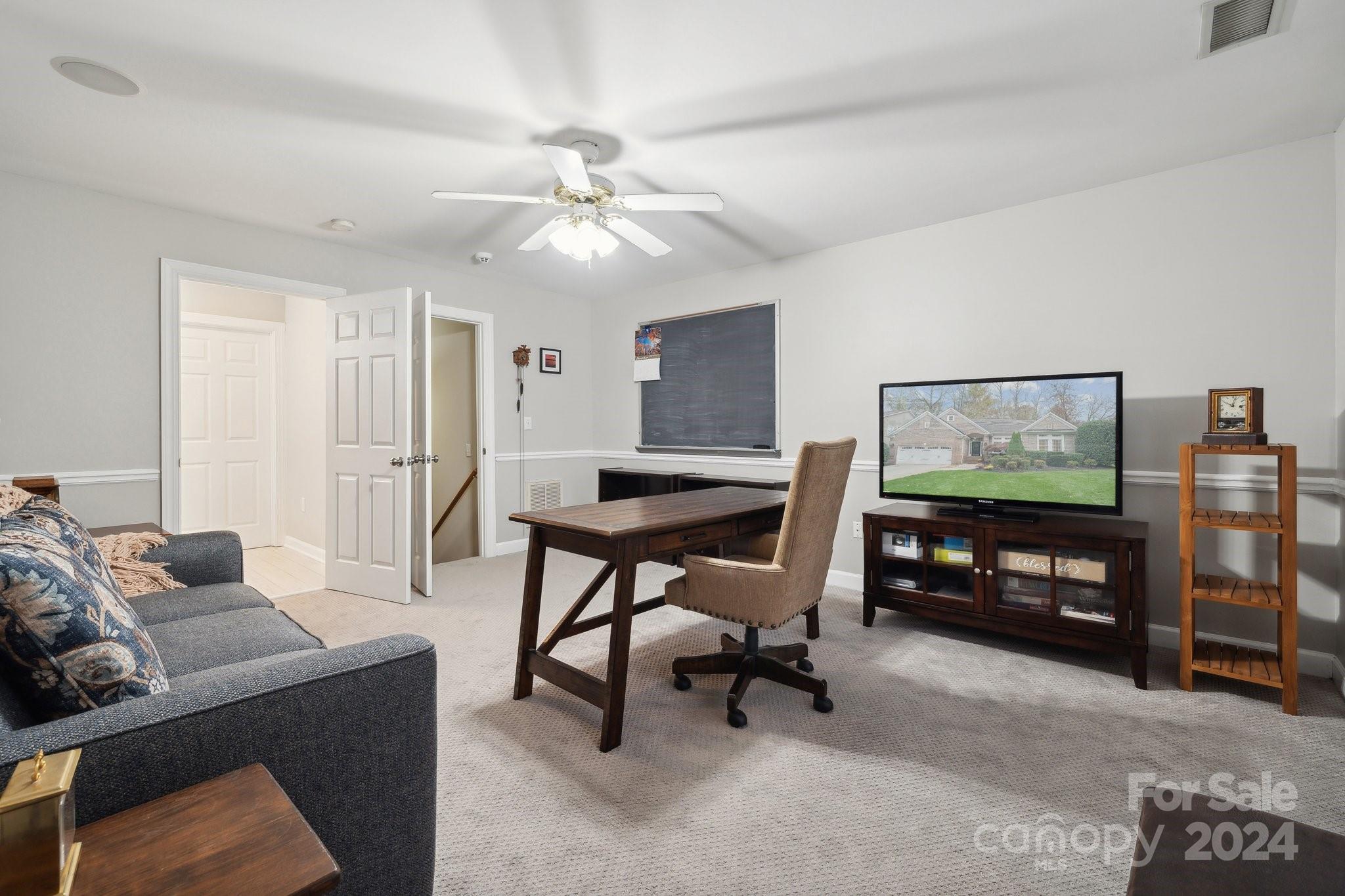 8610 Brentfield Road Huntersville, NC 28078 - Photo 34 of 48 a living room with furniture and a flat screen tv with kitchen view