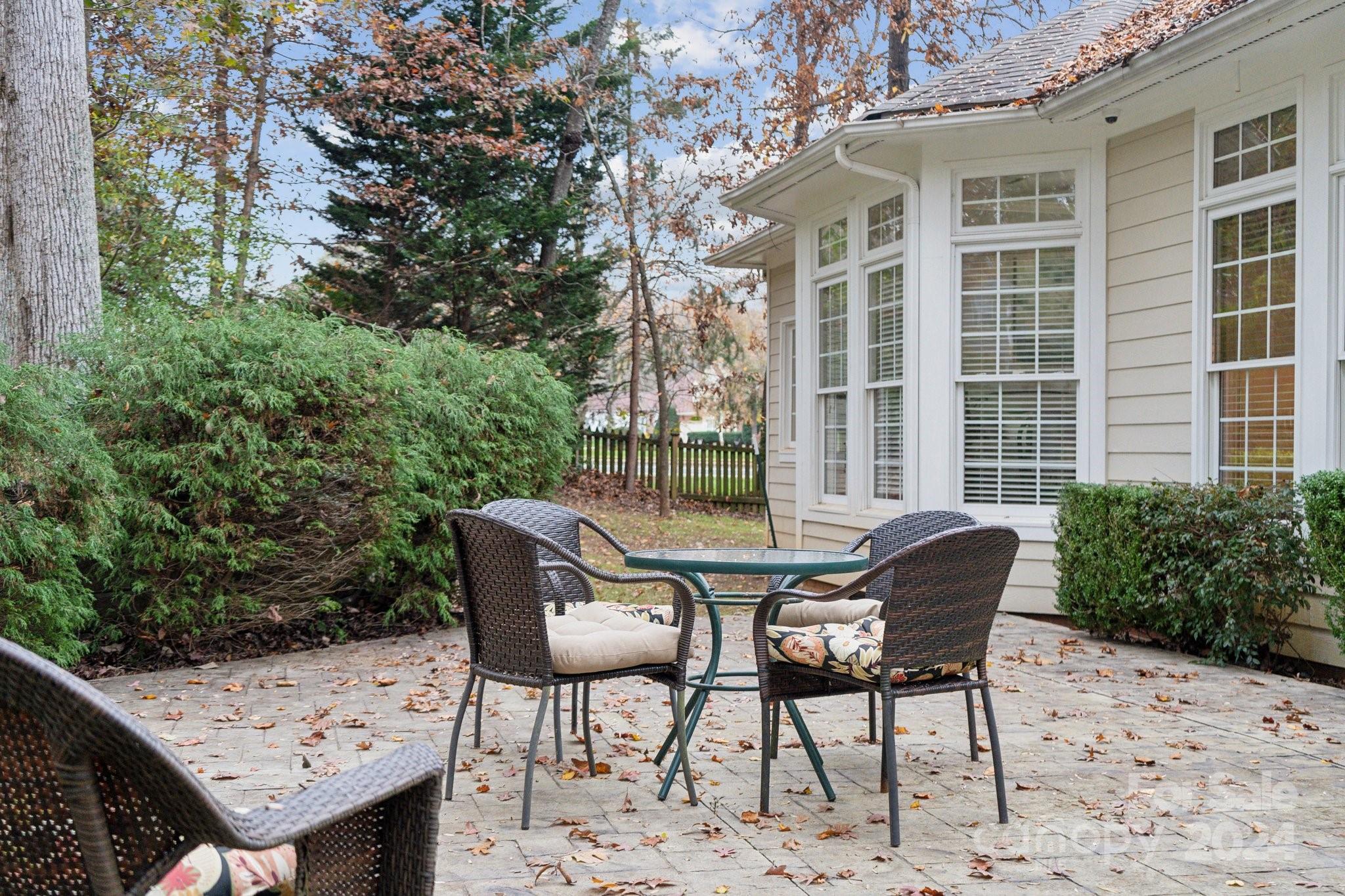 8610 Brentfield Road Huntersville, NC 28078 - Photo 38 of 48 a patio with table and chairs and potted plants