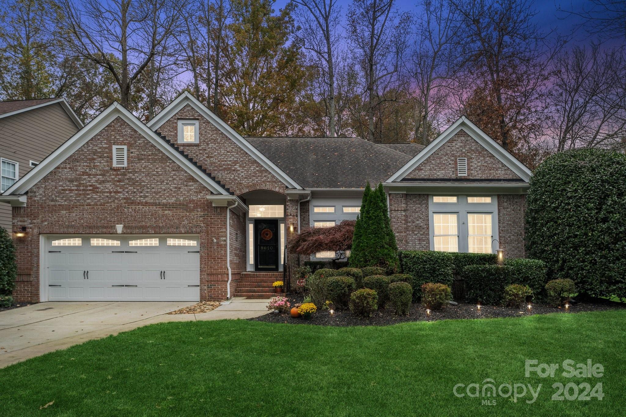 8610 Brentfield Road Huntersville, NC 28078 - Photo 41 of 48 a front view of a house with a garden and plants