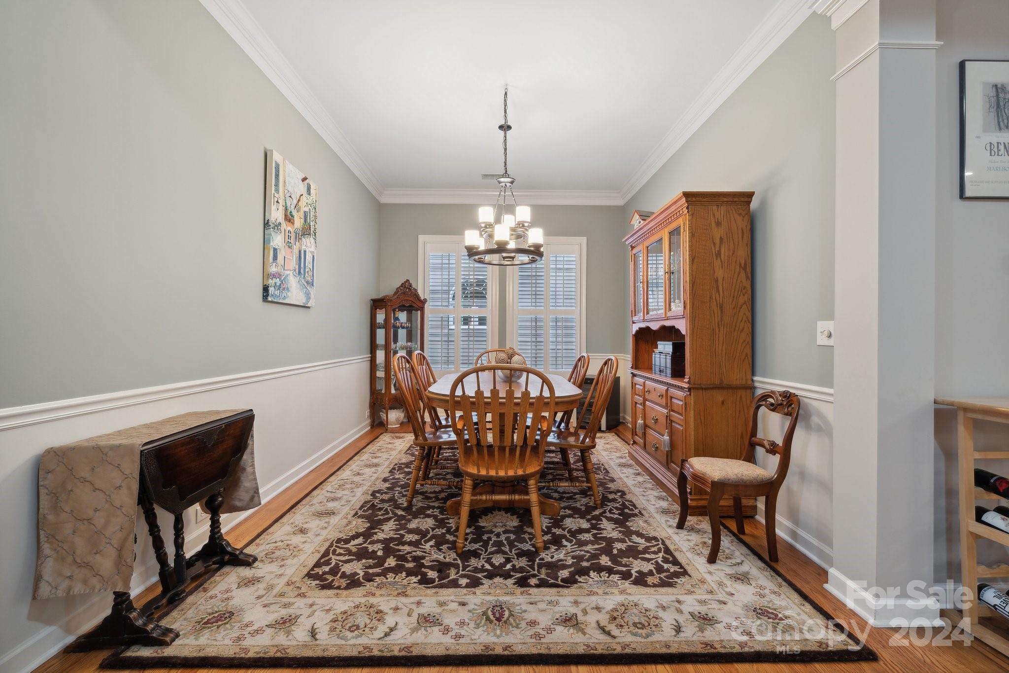 8610 Brentfield Road Huntersville, NC 28078 - Photo 8 of 48 a dining room with furniture a rug and wooden floor