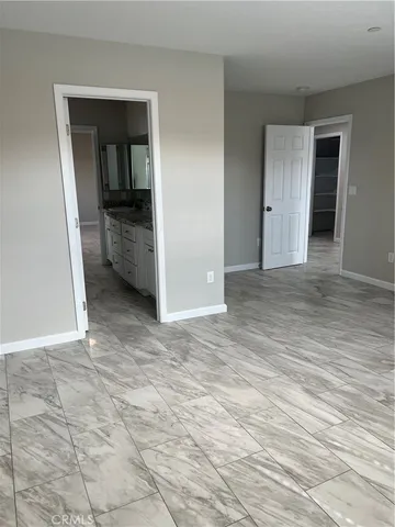 a view of an empty room and bathroom
