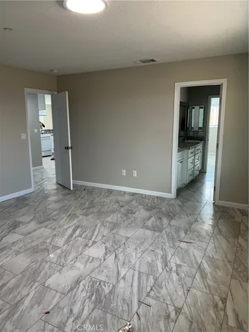 a bathroom with a granite countertop sink toilet and a mirror
