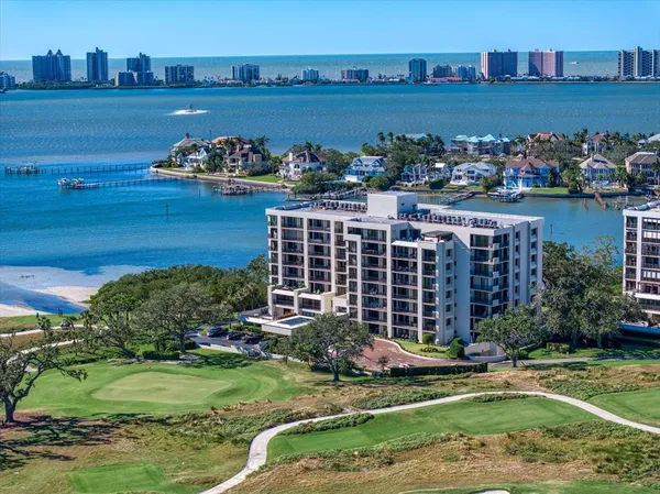 a view of a house with a yard and a pond