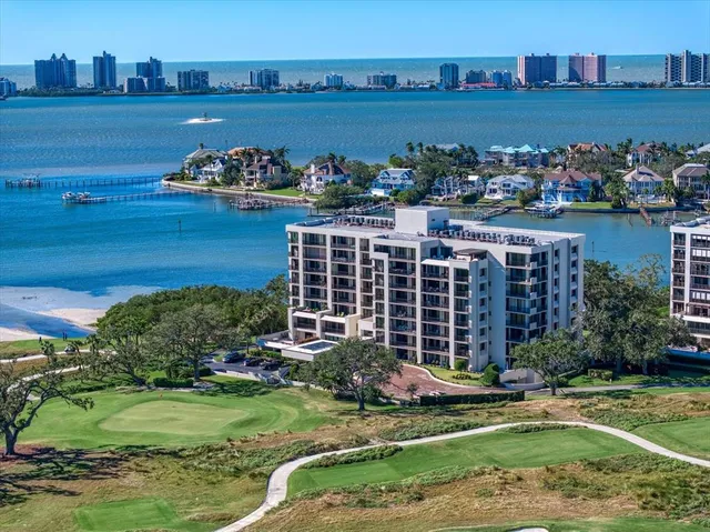 a view of a house with a yard and a pond