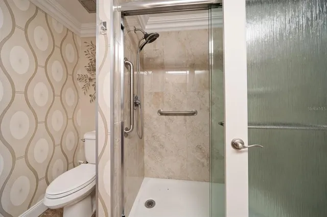 a living room with furniture a chandelier and a flat screen tv