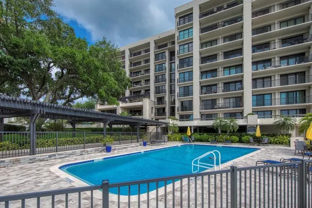 a swimming pool with outdoor seating and yard