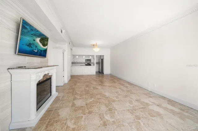 a kitchen with a sink chandelier and living room view