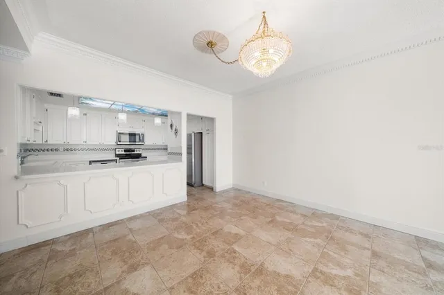 a kitchen with stainless steel appliances a refrigerator and cabinets