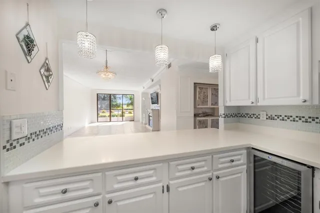 a kitchen with stainless steel appliances granite countertop a refrigerator stove top oven and sink