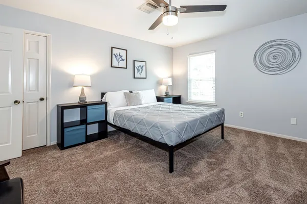 a bedroom with a bed and a chandelier