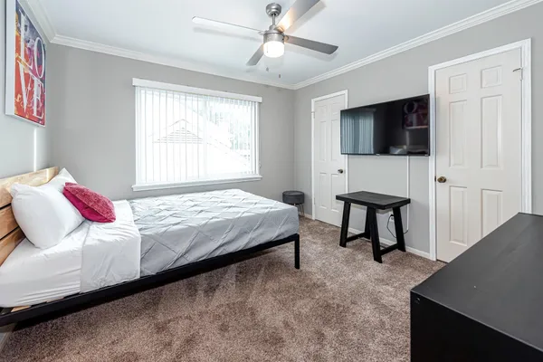 a bedroom with a bed and a flat screen tv