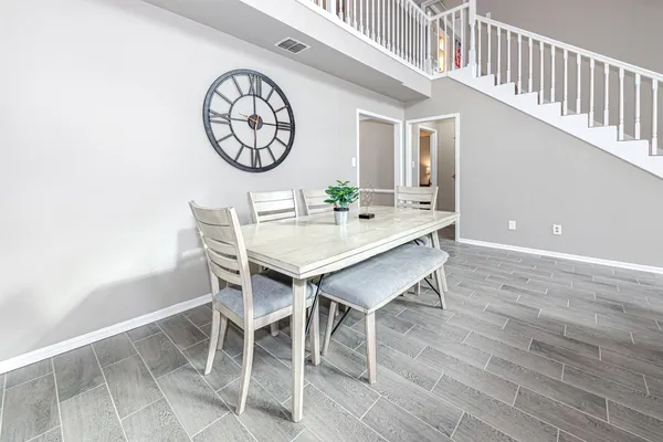 a view of a dining room with furniture and wooden floor