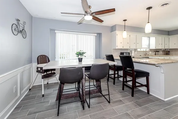 a view of a dining room with furniture and window