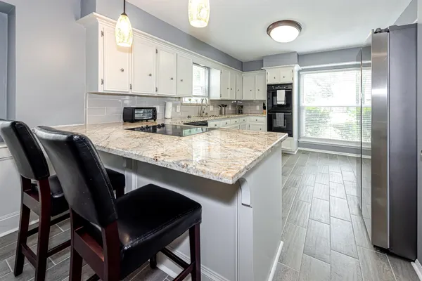 a kitchen with a table chairs and cabinets