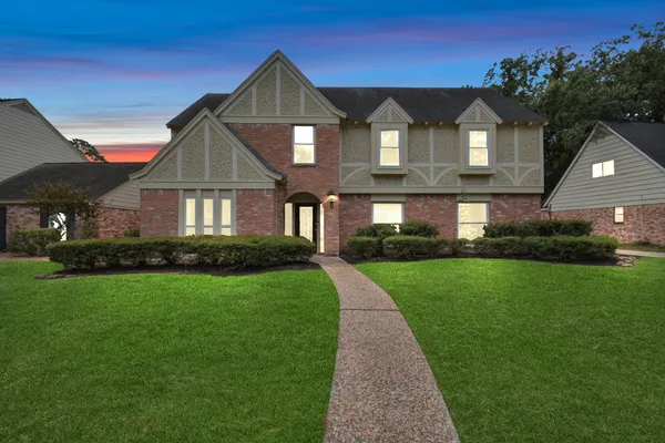 a front view of a house with a yard