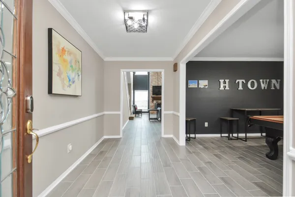 a view of a hallway view with wooden floor and dining room