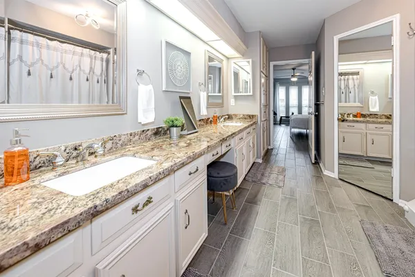 a kitchen with granite countertop a sink stove and cabinets