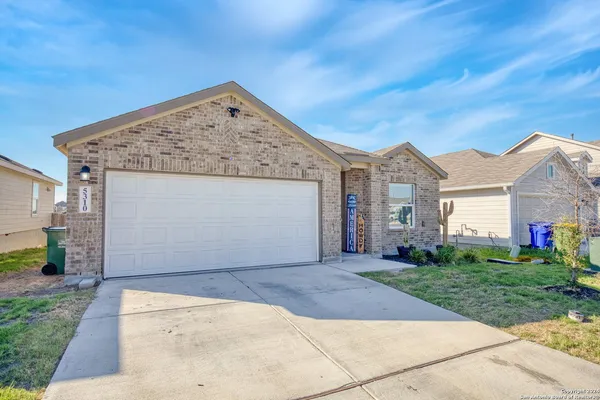 a view of a house with a yard and garage