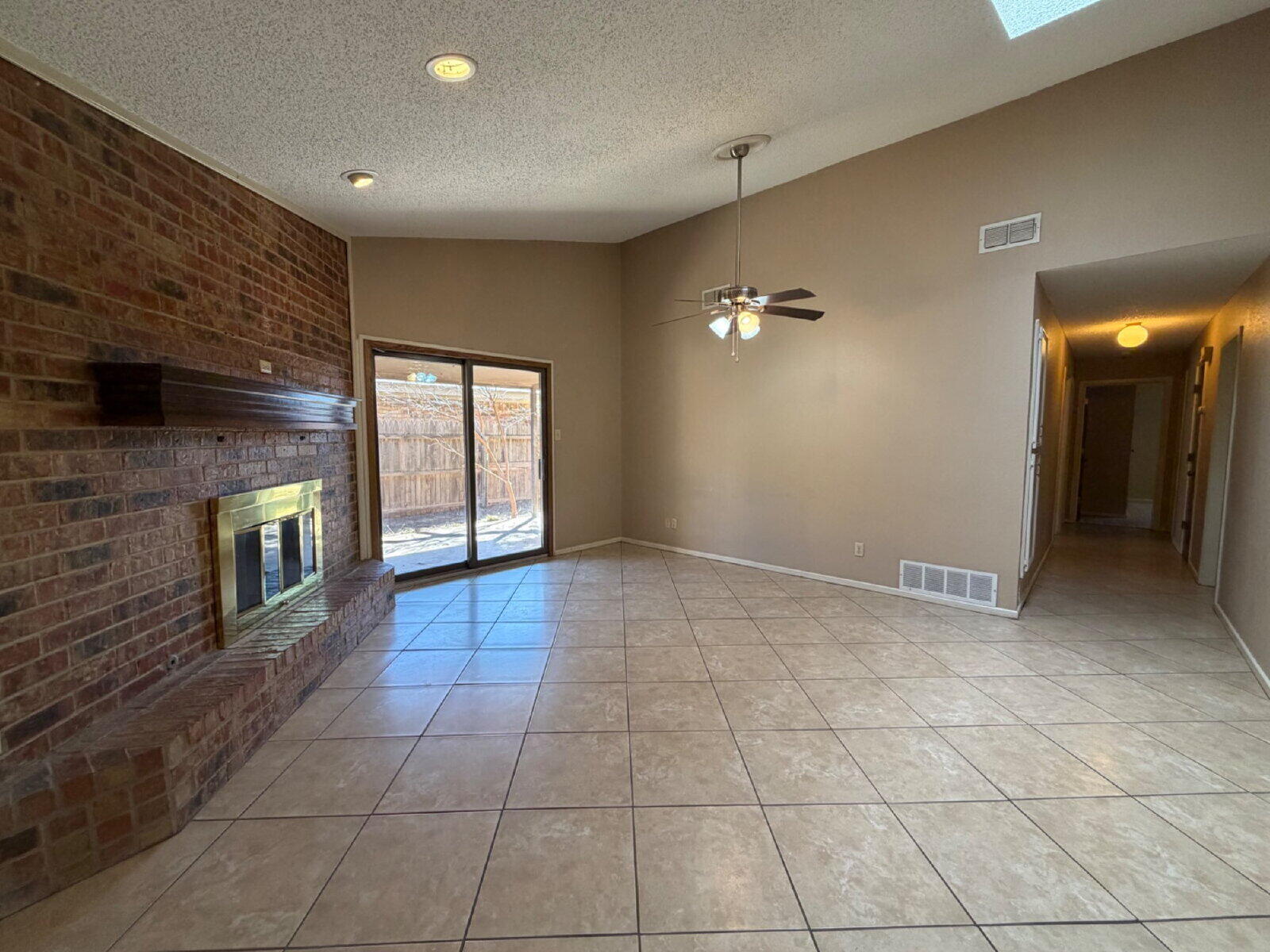3107 75th Street, Unit A Lubbock, TX 79423 - Photo 2 of 12 a view of an empty room with a fireplace