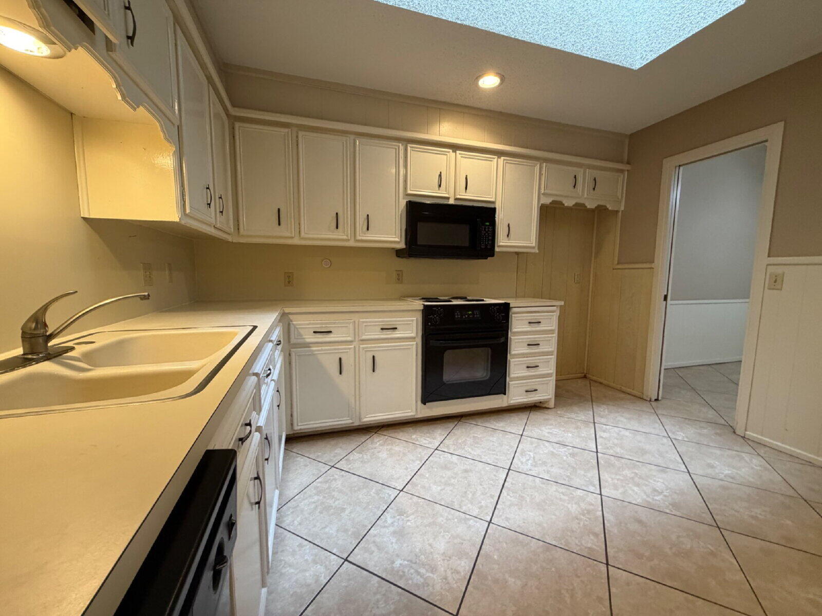 3107 75th Street, Unit A Lubbock, TX 79423 - Photo 5 of 12 a kitchen with a sink a stove and cabinets