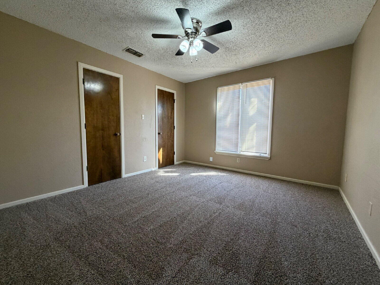 3107 75th Street, Unit A Lubbock, TX 79423 - Photo 6 of 12 a view of a livingroom with a chandelier fan and windows