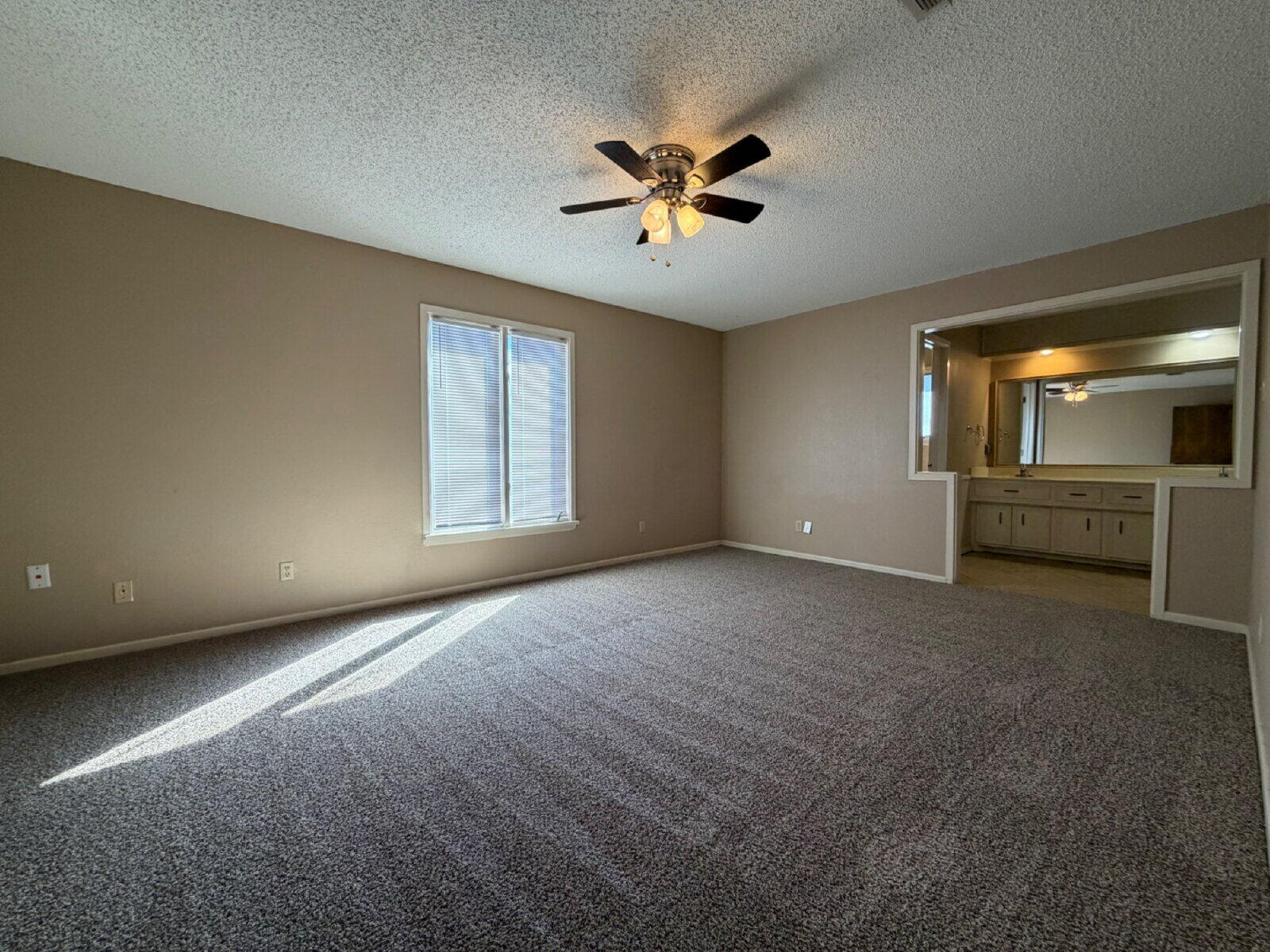 3107 75th Street, Unit A Lubbock, TX 79423 - Photo 8 of 12 a view of an empty room with a window