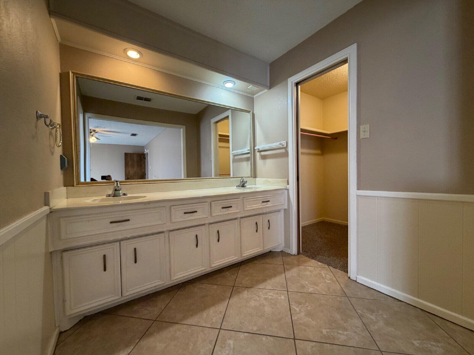3107 75th Street, Unit A Lubbock, TX 79423 - Photo 10 of 12 a spacious bathroom with a granite countertop sink and a mirror