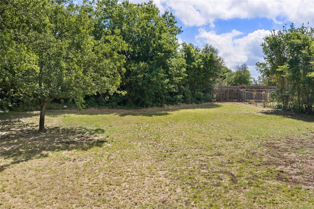 440 Williams Road Lorena, TX 76655 - Photo 13 of 19 Expansive grassy area with mature trees and a partial wood fence
