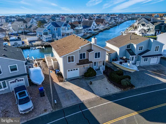 an aerial view of a house with wooden floor and city view