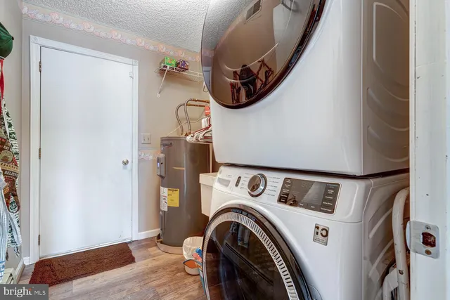 a kitchen with refrigerator and cabinets