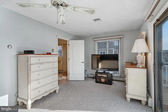 a bedroom with a large bed and a large window