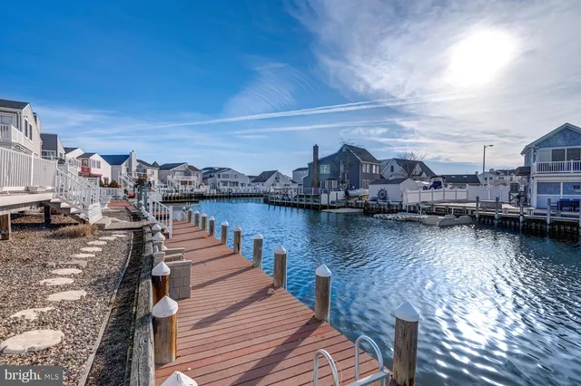 a view of a lake with boats and trees in the background