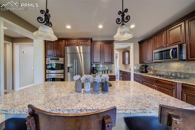 848 Spectrum Loop Colorado Springs, CO 80921 - Photo 15 of 34 Large Island and Dacor built in refrigerator