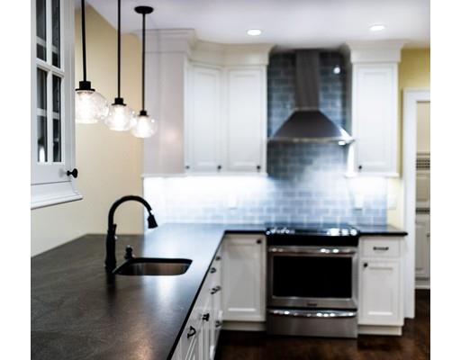 28 Clarke Road Needham, MA 02492 - Photo 8 of 21 a kitchen with stainless steel appliances granite countertop a sink and a refrigerator