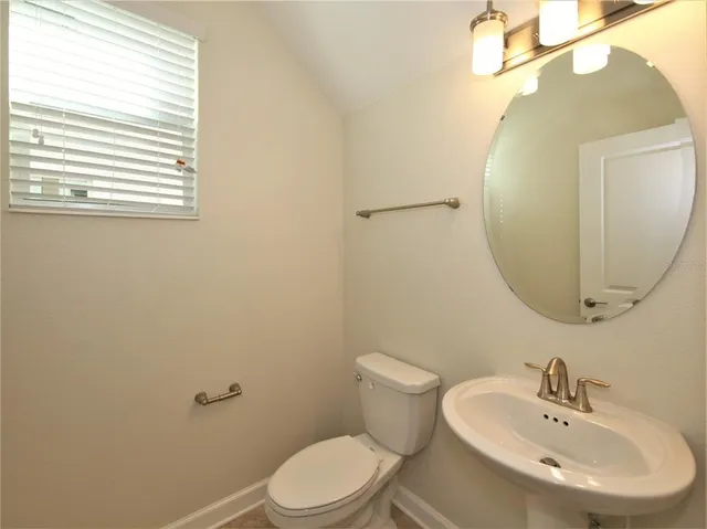 a bathroom with a sink a mirror and a toilet