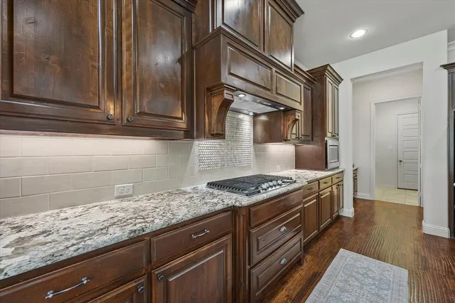 a kitchen with granite countertop cabinets and steel stainless steel appliances