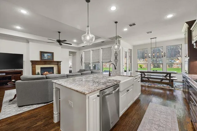 a large kitchen with a table and chairs in it